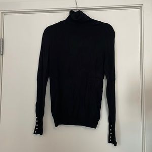 Zara black turtleneck with pearl detail at wrist cuff